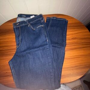 Dark wash denim jeans with a slim fit.